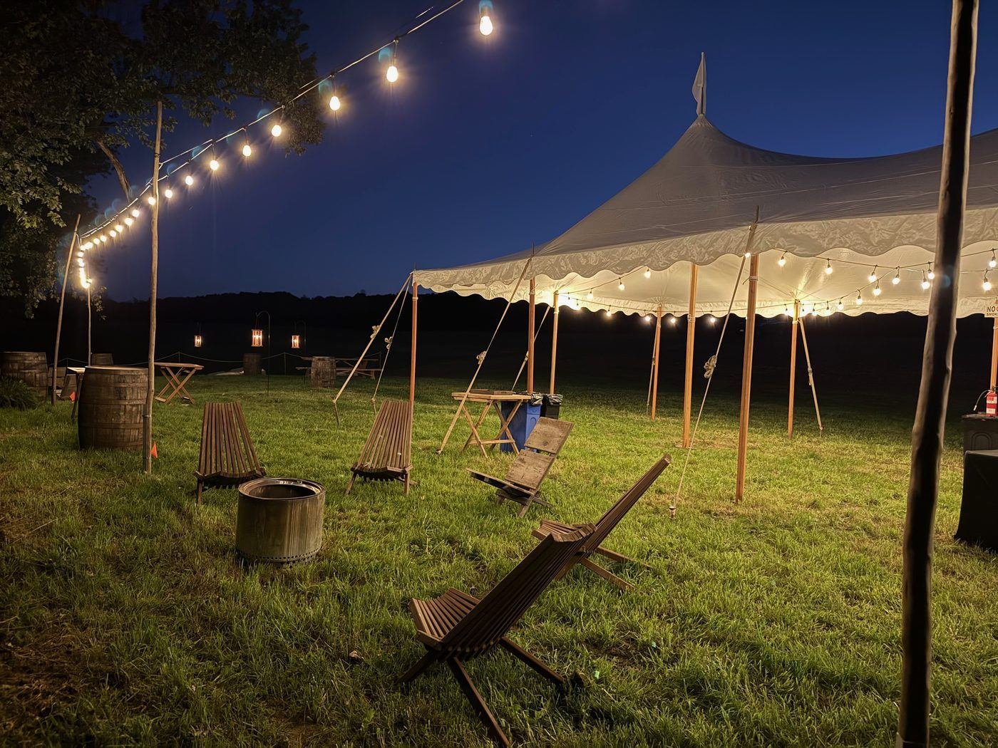 Sailcloth tent at dusk with string lights