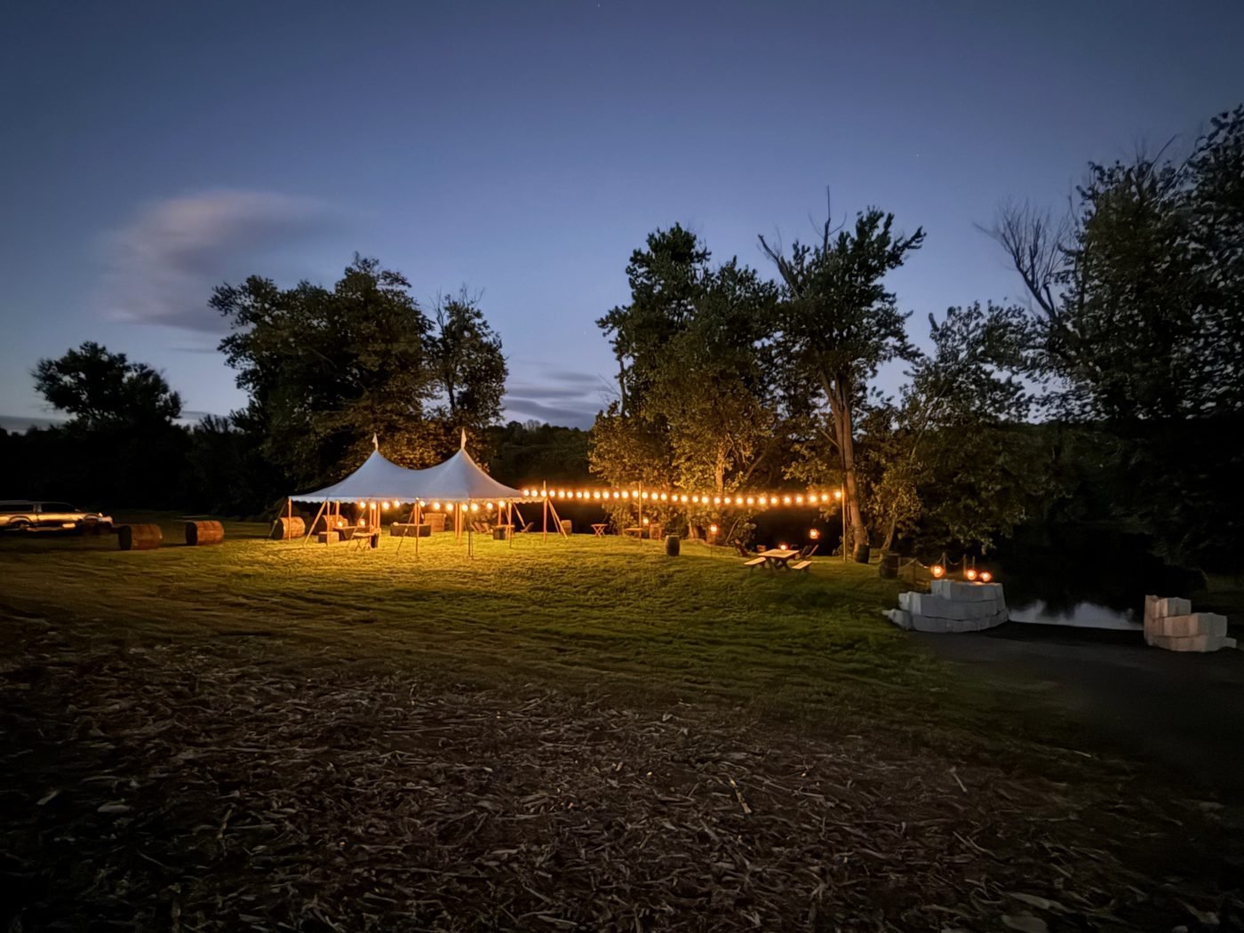 Tent at dusk across the field