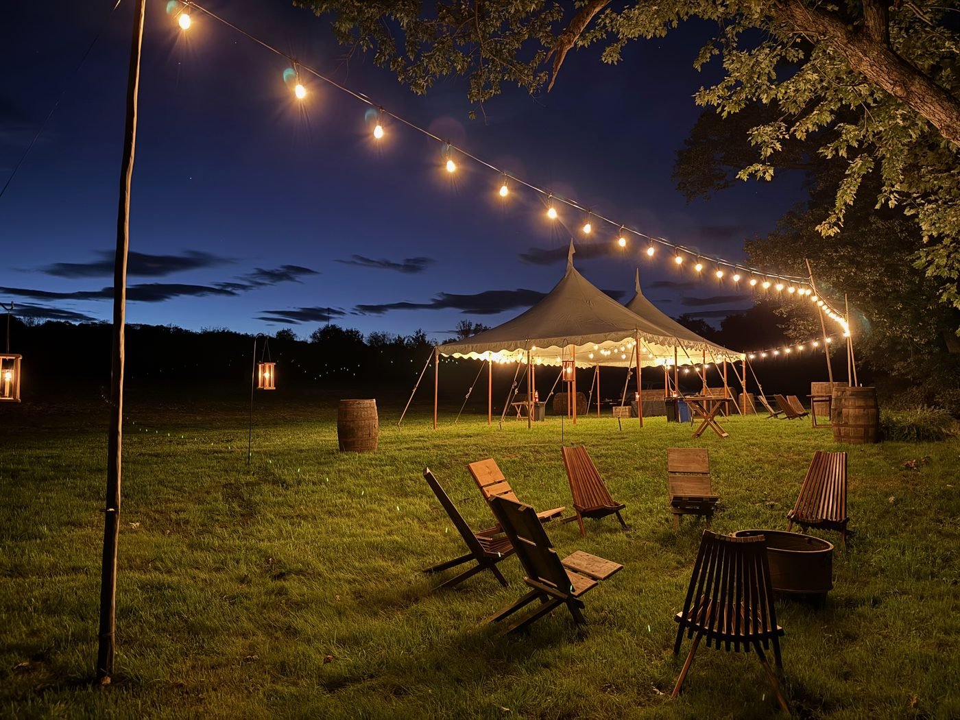 Wide view of tent and string lights at night