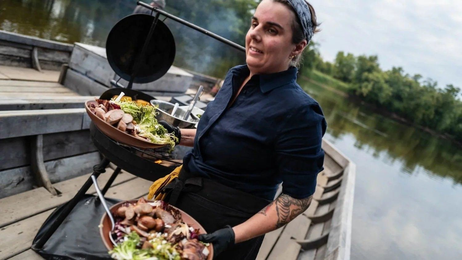 Chef Sarah serving guests aboard the batteau