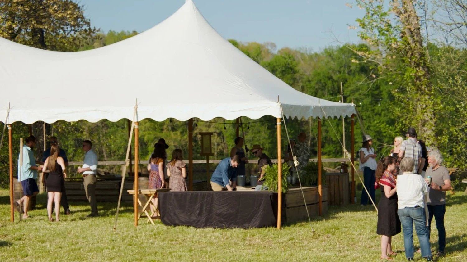 Guests under the sailcloth tent during the day